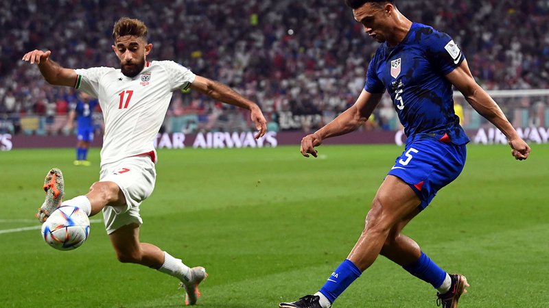 epa10337152 Ali Gholizadeh of Iran in action against Antonee Robinson (R) of the USA during the FIFA World Cup 2022 group B soccer match between Iran and the USA at Al Thumama Stadium in Doha, Qatar, 29 November 2022.  EPA-EFE/Neil Hall